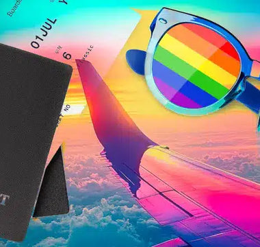 A passport and rainbow sunglasses rest over an airplane wing view with a vibrant, colorful sky in the background, symbolizing LGBTQ+ travel and the spirit of adventure—perfect for those seeking the best poppers for bottoms on their journeys
