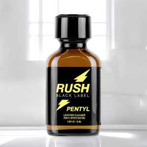 "RUSH BLACK LABEL PENTYL" in yellow text, featuring a lightning bolt symbol above "RUSH" and "PENTYL NITRITE MIXTURE LEATHER CLEANER" in small print below. The contents of this Rush Black Label Pentyl Poppers 24ml bottle are 24ml (0.8 fl oz).